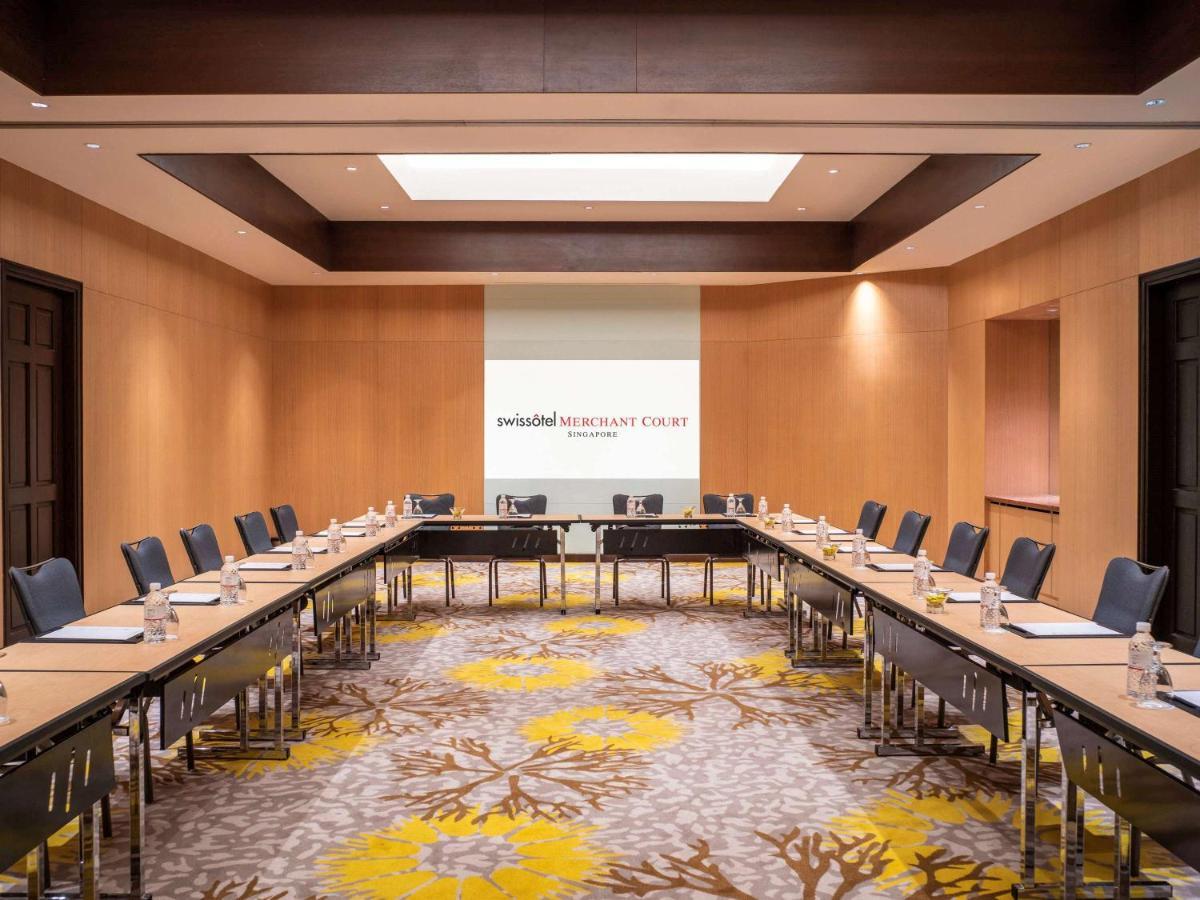 Paradox Singapore Merchant Court At Clarke Quay Εξωτερικό φωτογραφία The image shows a professional conference room designed for meetings. It features a large rectangular arrangement of tables with black chairs surrounding them. The walls are made of light-colored wood, contributing to a modern and sophisticated atmos